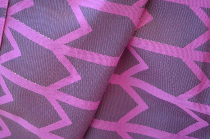 Close-up of the design from the other side of the wrap showing a medium gray background with pink zig-zag pattern
