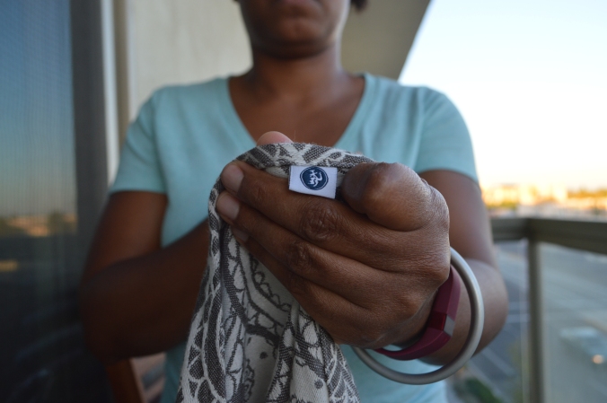 Image shows a closeup of the middle marker held close to the camera by a brown skin woman