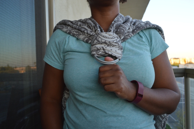 Image shows the threaded wrap placed over the chest of the woman with one tail over each shoulder